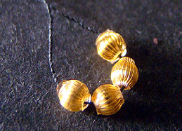 hollow glass beads with 24 carat gold plating inside